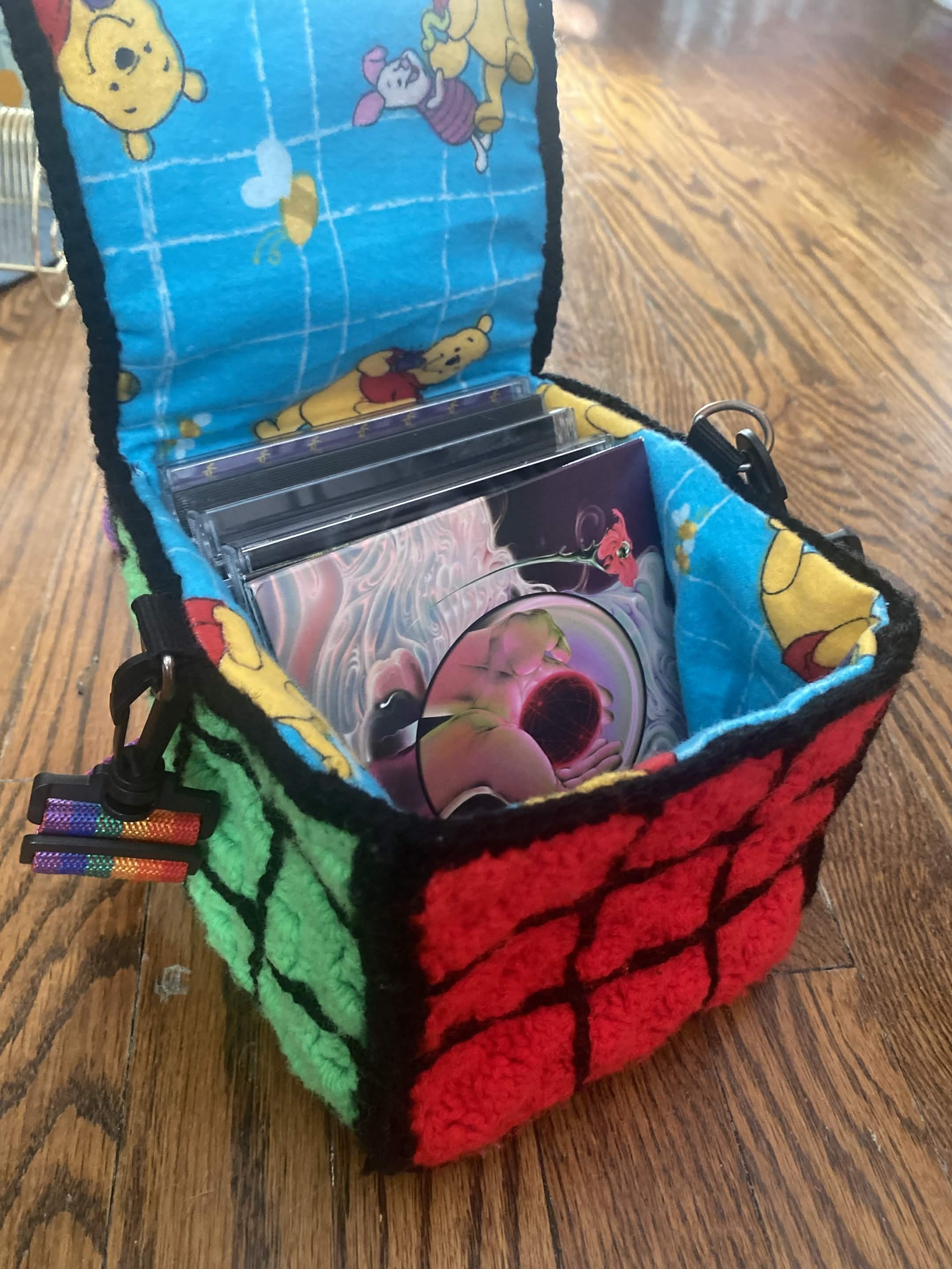 bag open, added lining gives interior a winne-the-pooh pattern. cds in the bag